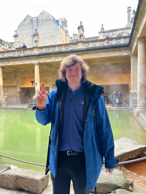 A member of the Roman Baths team in front of the Great Bath 