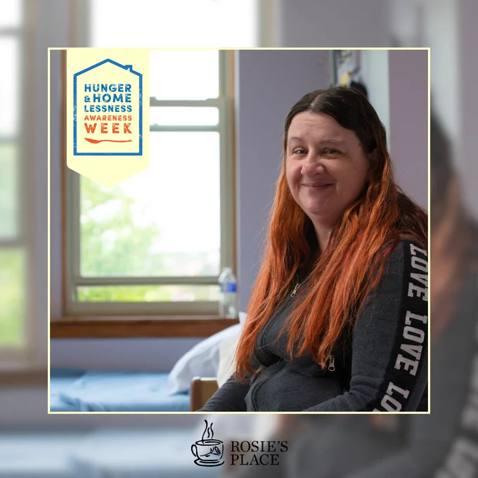 Woman with long red hair sitting in a room with a window, with a logo for Hunger & Homelessness Awareness Week and Rosie's Place.
