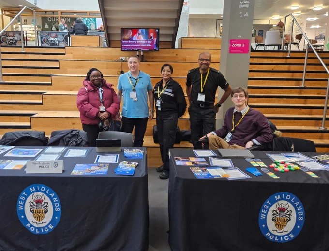 Outreach team standing with members of the recruitment team and a student at BCU.