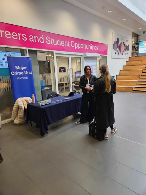 Major crime unit standing by their table at BCU