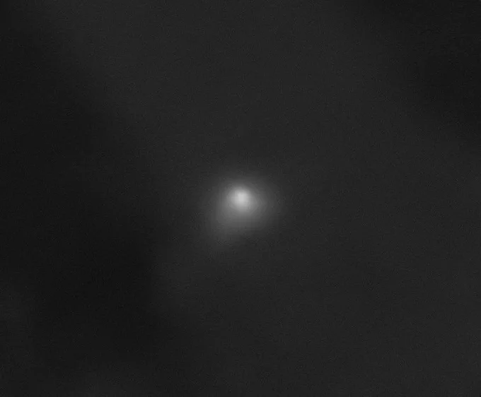 A blurry, black and white image shows a faint, glowing spot in the center surrounded by a hazy, diffuse area. The image, from the High Resolution Imaging Science Experiment (HiRISE) camera aboard NASA’s Mars Reconnaissance Orbiter, shows interstellar comet 3I/ATLAS on Oct. 2, 2025. At the time it was imaged, the comet was about 0.2 astronomical units (19 million miles, or 30 million kilometers) from the spacecraft.

Image Credit: NASA/JPL-Caltech/University of Arizona