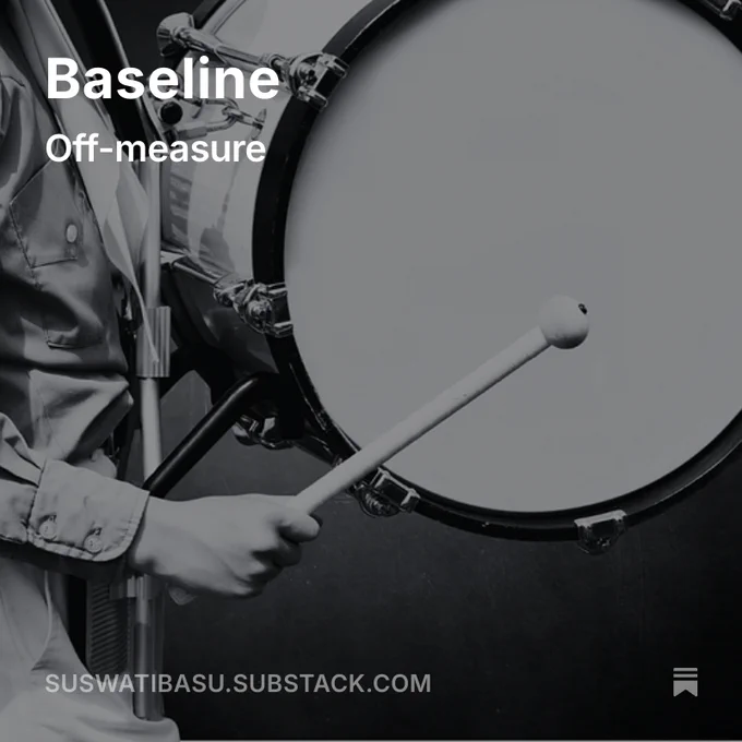 “A person in a uniform plays a large bass drum with a mallet. The black-and-white image includes overlaid text reading ‘Baseline – Off-measure’ and a footer with ‘suswatibasu.substack.com.’”