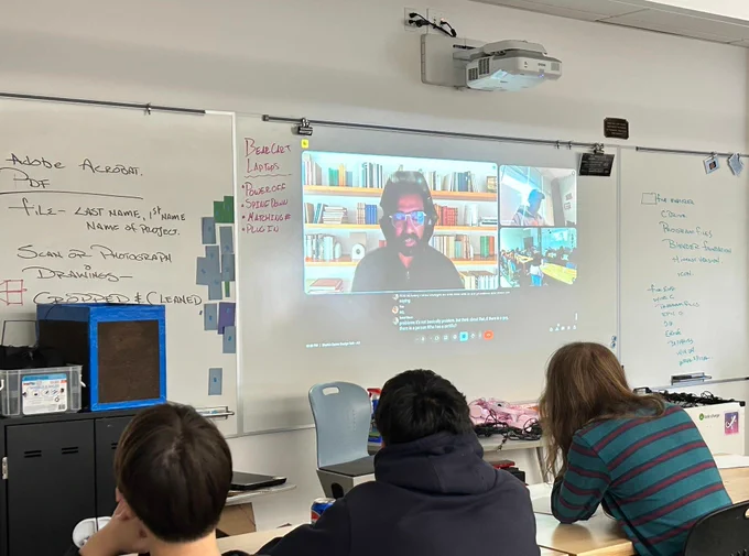 Students listen to a presenter on a WebEx call