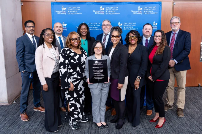 Representatives from the College of Education & Human Development's Principals Center and educational leadership programs pose for a photo with staff from Fulton County Schools’ Department of Professional Learning and Leadership Development