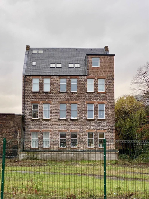 This is the ‘B’ listed former Potato and Grain Merchant’s warehouse on Glasgow’s Hunter Street in 2025 after it has been transformed into a sustainable reuse as new homes for rent. The building now has a new slate roof and repointed walls and the overgrown vegetation and trees has been cut right back.