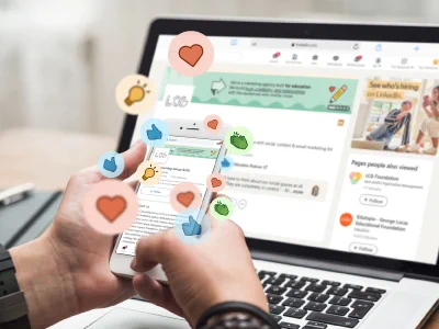 A smartphone with social media icons floating around it with a laptop showing social media management software in the background.
