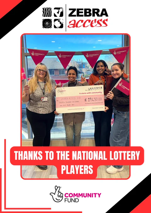 A group of four smiling people stand indoors holding an oversized cheque for £19,450 from The National Lottery Community Fund. They are surrounded by pink bunting and holding small community fund flags. 
Above the group is the Zebra Access logo, and below is the text “Thanks to the National Lottery Players” along with the Community Fund logo featuring a hand with crossed fingers.