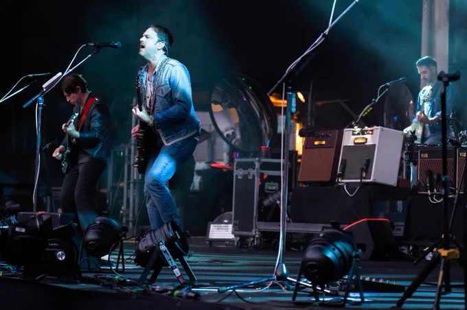 Kings of Leon perform on stage.