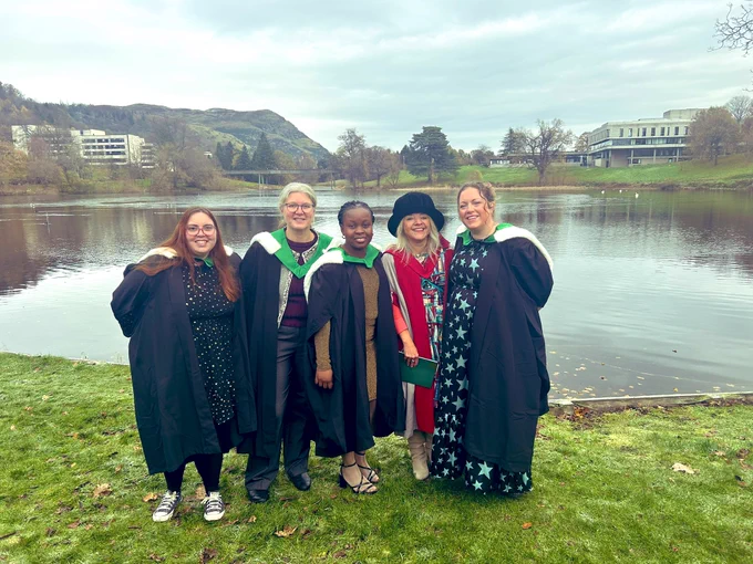 Students graduating in front of the loch at Stirling University