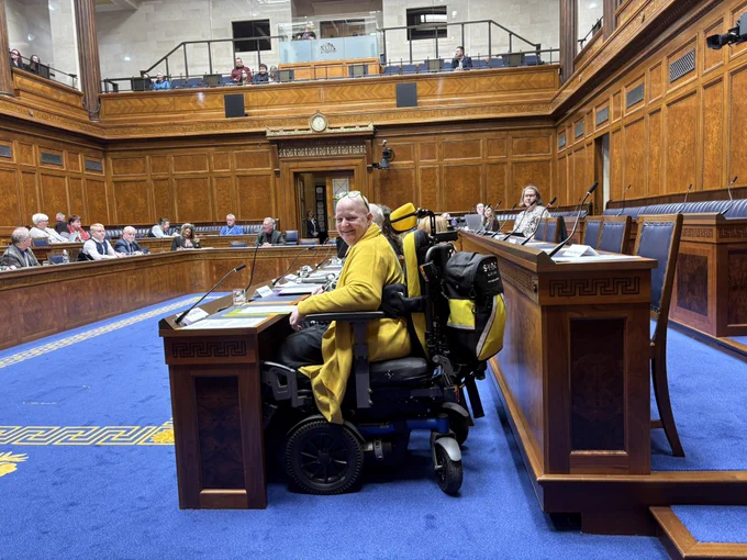 Amanda Paul in the Assembly chamber at the disabled people’s parliament.