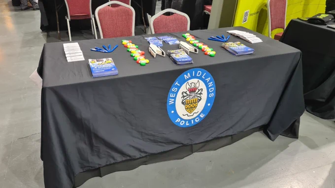 West Midlands Police table set up with highlighters and leaflets at the CTP event.