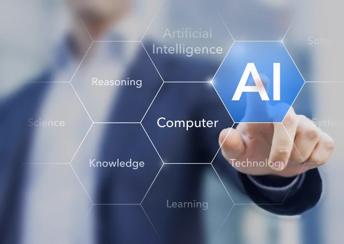 Image of a person’s hand tapping screen, chosen text reads “AI” and other text reads, “Reasoning, Science, Knowledge, Learning, Computer, and Technology”.