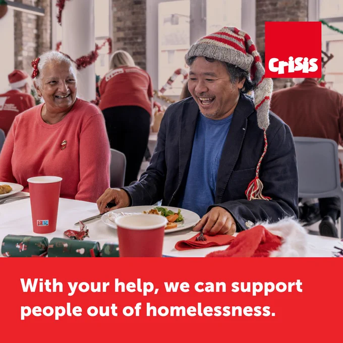 Two individuals sharing a joyful moment at a "Crisis at Christmas" charity event, sitting at a table decorated with festive elements. 
Caption reads - With your help we can support people out of homelessness.