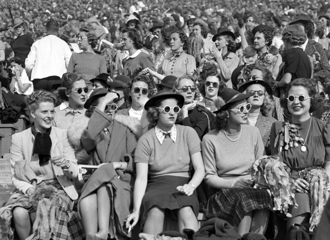 In this black-and-white photo from 1938, football fans — many of them donning hats and sunglasses — watch the Big Game at Memorial Stadium in Berkeley.