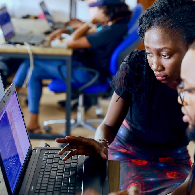 A woman and man at a laptop