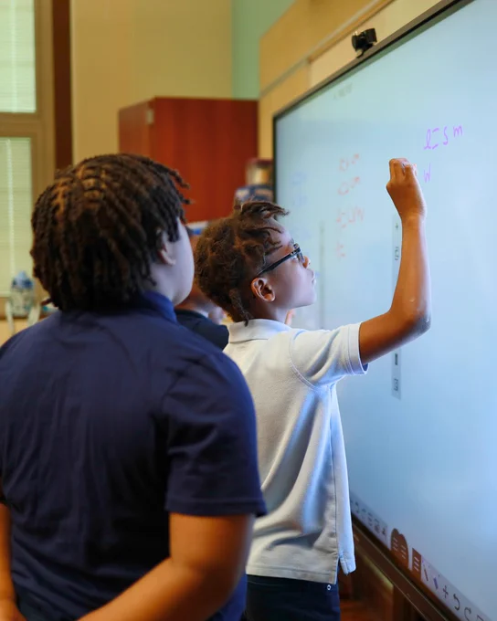 Clear Touch students using interactive whiteboard and drawing with their finger on the smart board