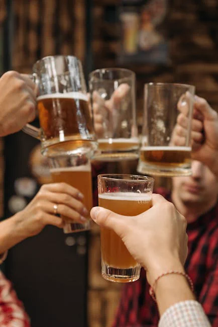 Group of friends clinking beer mugs, enjoying a fun gathering indoors.