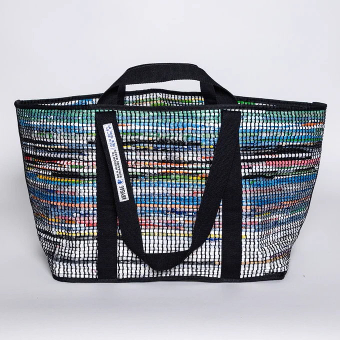 Any ANYBAG Weekender in Gotham colorway, which is hand woven in New York City from Upcycled Single-Use plastic bags into a beautiful, artisanal, sustainable fashion lifestyle staple. The bag is durable and multi-purpose, backed by a Lifetime Guarantee. It is Made In the USA with ethical labor by the same artisans that make luxury fashion goods for top brands. 