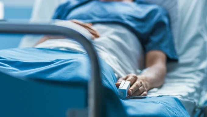 A sick patient in a hospital bed. 