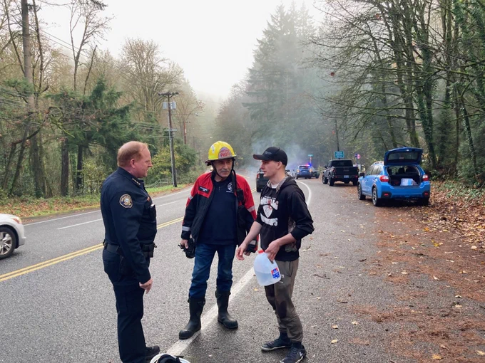 Chief talks to two people at accident scene