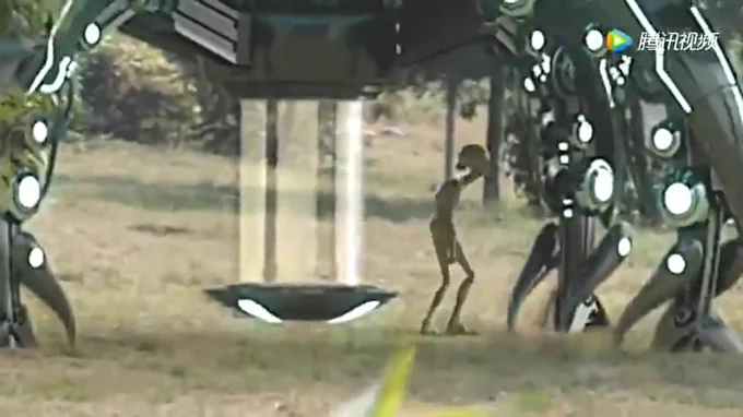 This image is a refined, high-detail enhancement created from a raw video clip originally found on X .

The scene shows what appears to be a humanoid alien figure standing in an open, grassy field. The being is extremely slender with elongated limbs, a narrow torso, and a smooth, rounded head. Its posture is relaxed, facing slightly toward a large machine.

To the left and above the alien is a large mechanical or extraterrestrial craft, supported by multiple robotic, jointed legs. Each leg contains bright circular lights that resemble energy modules or sensors.

Underneath the craft, a vertical column of light extends downward from the center, connecting to a small, disk-shaped platform hovering just above the grass. This column looks like a tractor beam, elevator beam, or scanning field.

The background shows blurred trees and natural scenery, suggesting a rural or forest-edge environment. The lighting looks natural and soft, as if filmed during early morning or late afternoo
