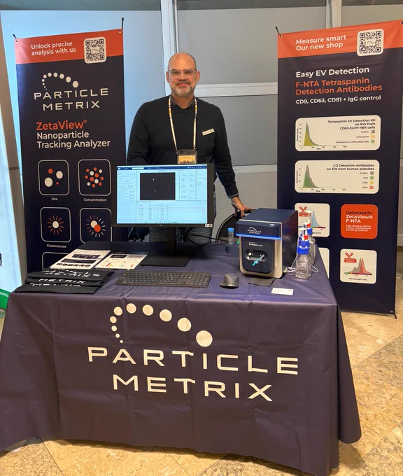Particle Metrix booth at SFNano 2025, featuring the ZetaView® Evolution system. Bertrand Damart is presenting the Nanoparticle Tracking Analysis (NTA) technology. The booth displays the instrument, posters, and demo setup for hands-on demonstrations.