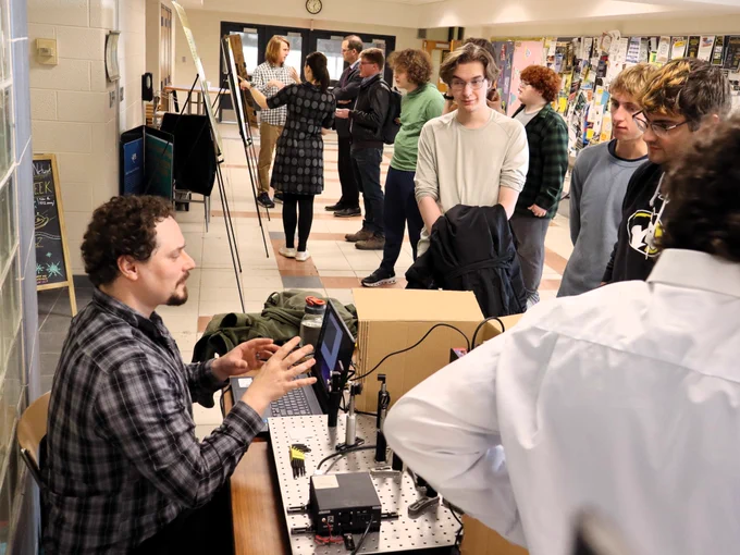 Dr. Seth Nelson discusses his research with physics undergraduates.