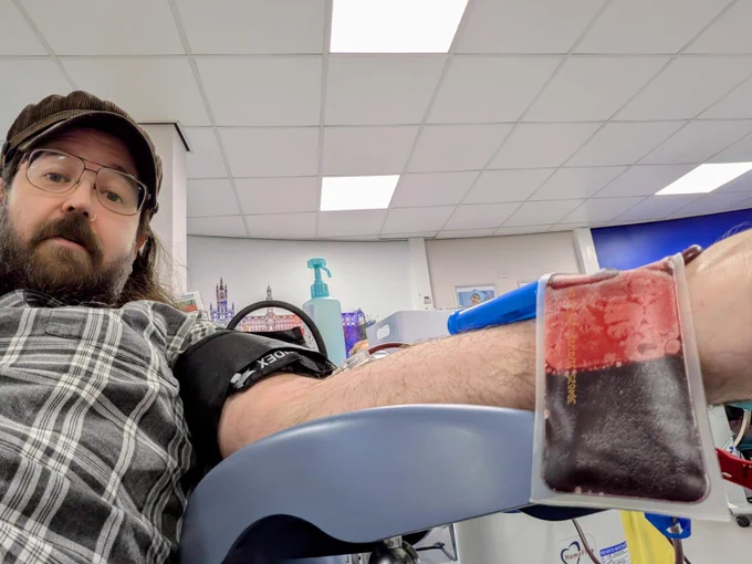 Staff member of BTM donating blood at donor centre
