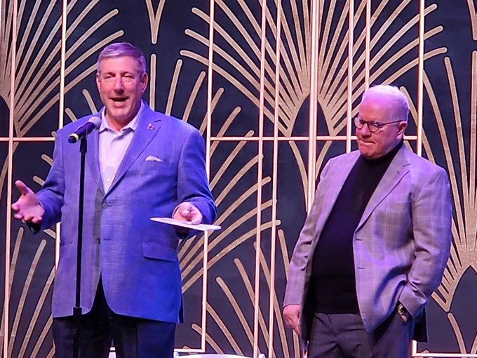 President Chris Brussalis of Point Park University speaking on stage introducing Emmy-nominated songwriting duo Kooman and Dimond