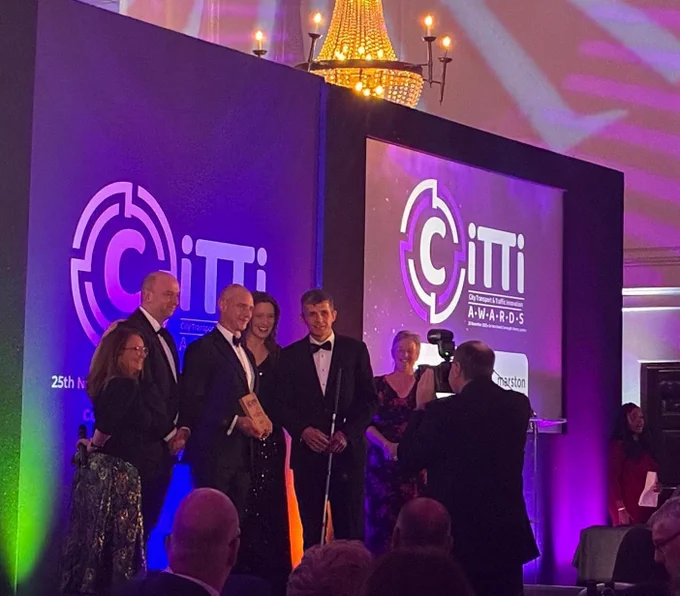 the award being presented to the team on stage