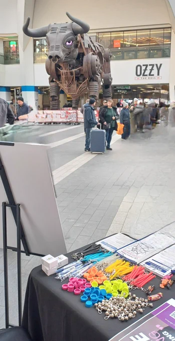 Picture shows our merch stand and ozzy the bull at new street station 