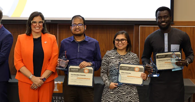 Three individuals proudly displaying awards and certificates at UT's annual Three Minute Thesis competition.