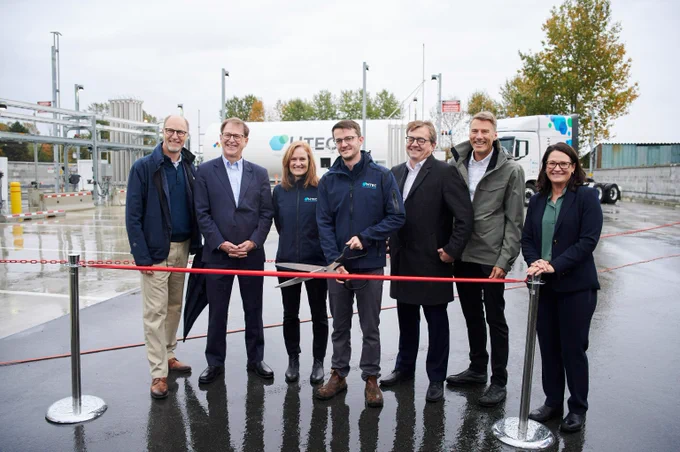 A group of people standing together at a ribbon-cutting ceremony.