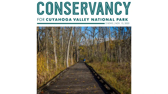 A Conservancy for CVNP logo and the word e-news with the date November 26, 2025. Beneath is an image of a person walking on a boardwalk that is part of the Towpath Trail in Cuyahoga Valley National Park.