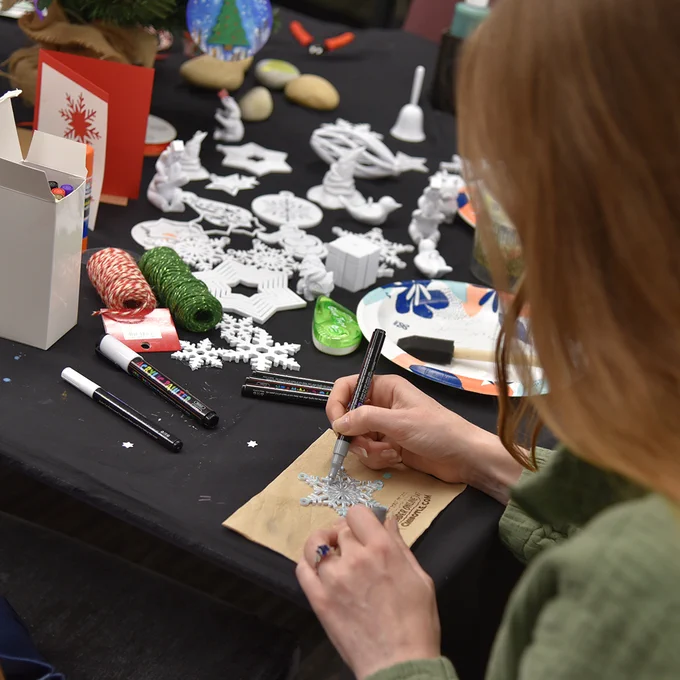 Student making a Christmas card in the Genesis Lab.