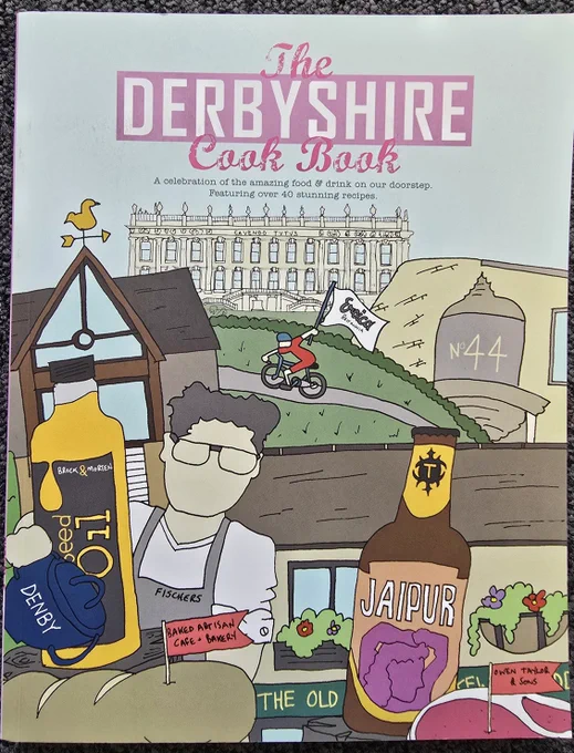 A bright colourful front cover showing a collage of hand drawn cartoon style images of local Derbyshire significance, such as Chatsworth House, other local buildings and images of local food. The title The Derbyshire Cook Book is prominently shown top centre of the cover.