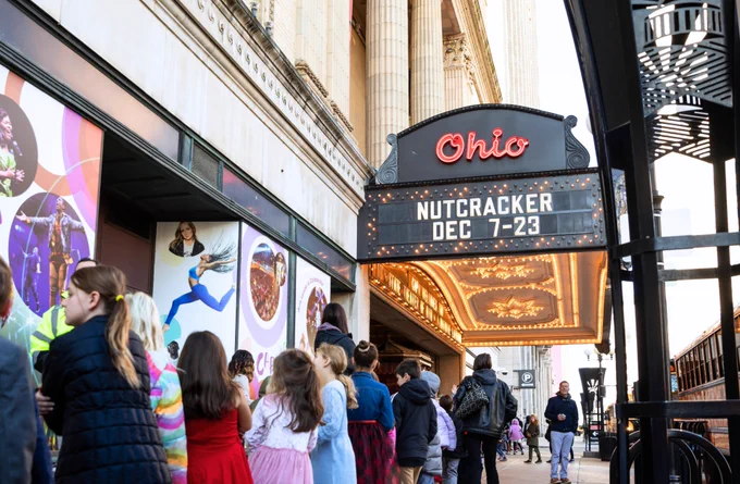 Children and adults lined up outside the Ohio Theatre under a marquee advertising The Nutcracker from Dec 7-23.