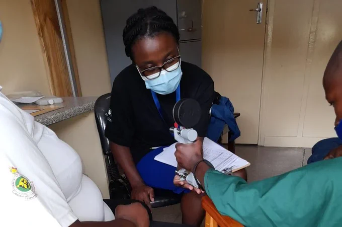 Study participant using a jamar dynamometer (grip strength machine) to assess muscle strength in the arms. (Credit: VITALITY RCT) 