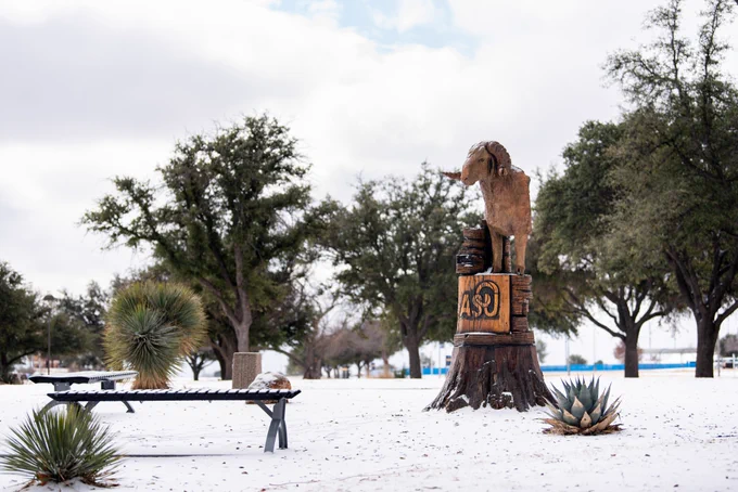 An image of an ASU statue with snow on the ground around it.
