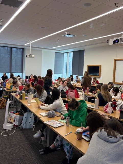group photo of all the second year OT students writing messages in the booklets
