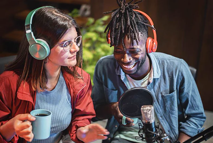 Photograph of two people recording for YouTube. 