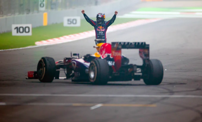 Seb continues to celebrate on track, with both arms raised.