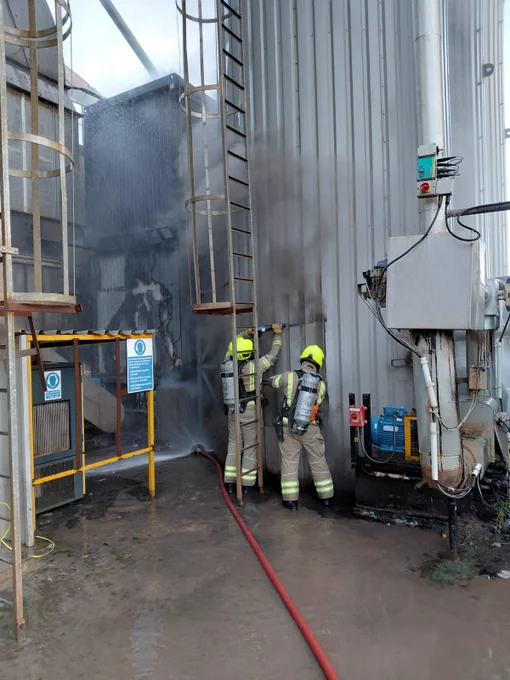 Firefighters dismantling a silo to monitor hotspots