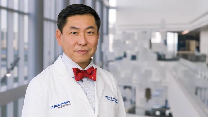 A professional headshot of Dr. Andrew Wang in his white lab coat.