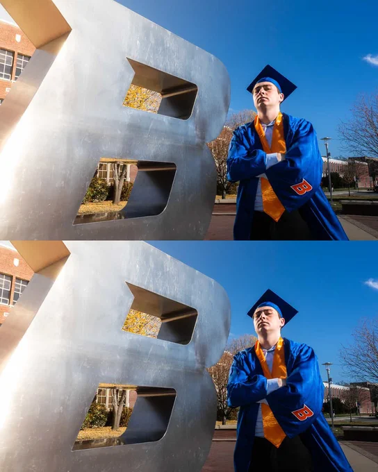 Boise State student wearing undergraduate regalia with arms crossed in the B Plaza.
