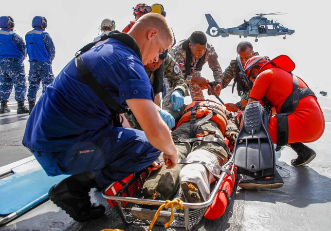 Members of the United States Coast Guard, Mexican navy, and the Dominican navy prepare a casualty for medical evacuation aboard the Oceanic Patrol Vessel Arm Veracruz in Guyana at Tradewinds 23, July 18. This training teaches personnel of various nations how to coordinate the safe medical evacuation of a casualty in a maritime environment. (U.S. Army National Guard photo by Sgt. Michael S Dunagan)