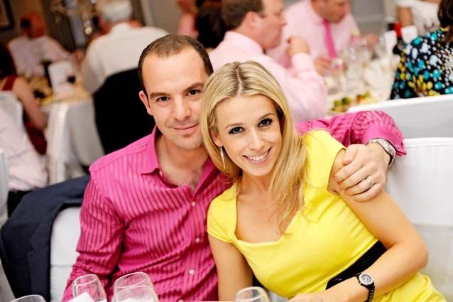 A young Martin Lewis in a bold pink striped shirt and young Lara Lewinton wearing a bold yellow dress