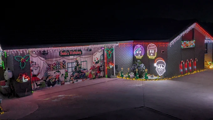 Christmas lights display on a house, including singing faces