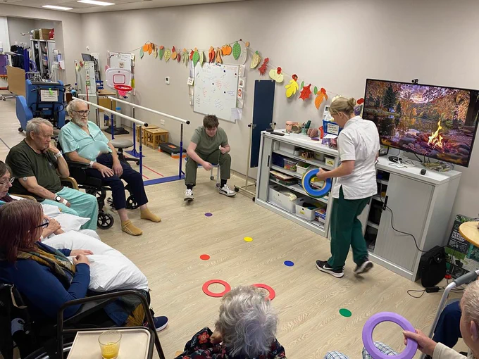 Therapists leading group activity session.