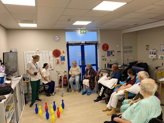 Therapists leading group activity session.